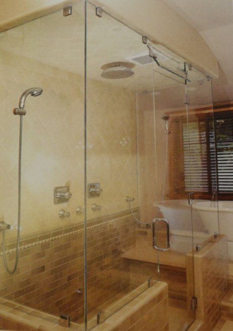 A bathroom with a walk in shower and a bathtub