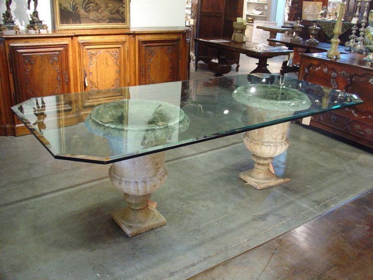 A glass table with a vase on top of it