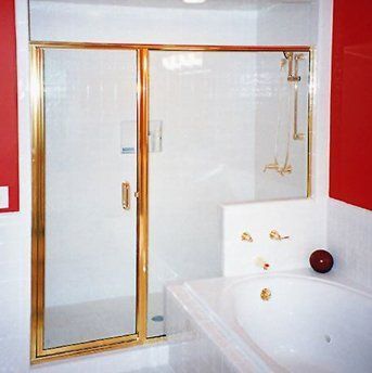 A bathroom with a bathtub and a shower