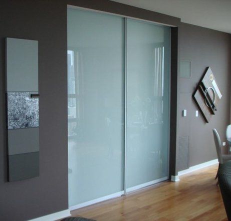 A room with sliding glass doors and a mirror on the wall