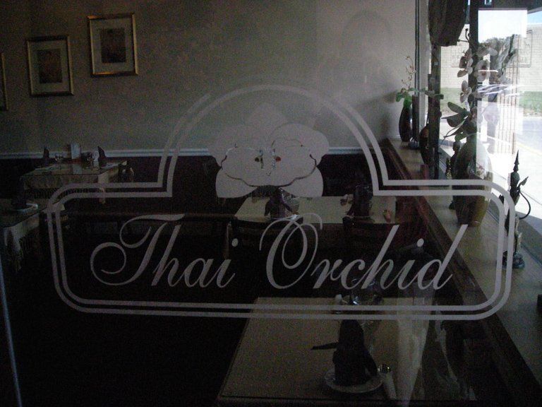 A restaurant with a sign that says thai orchid
