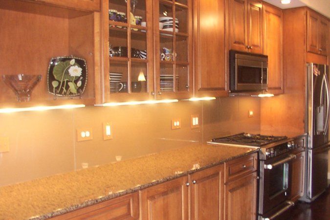 A kitchen with wooden cabinets and granite counter tops