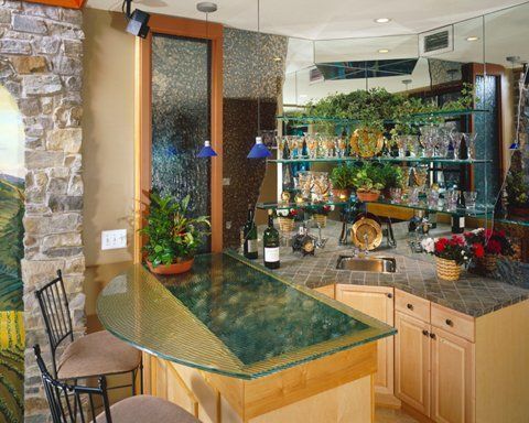 A kitchen with a bar and a bottle of wine on it