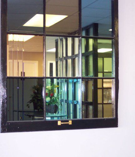 A window with a reflection of a building in it