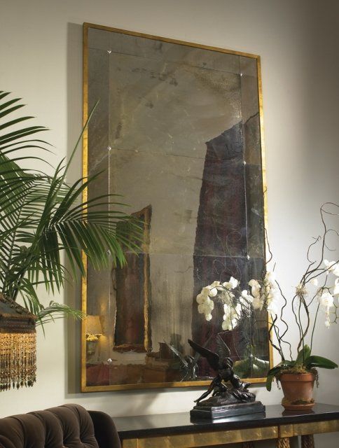 A living room with a large mirror on the wall