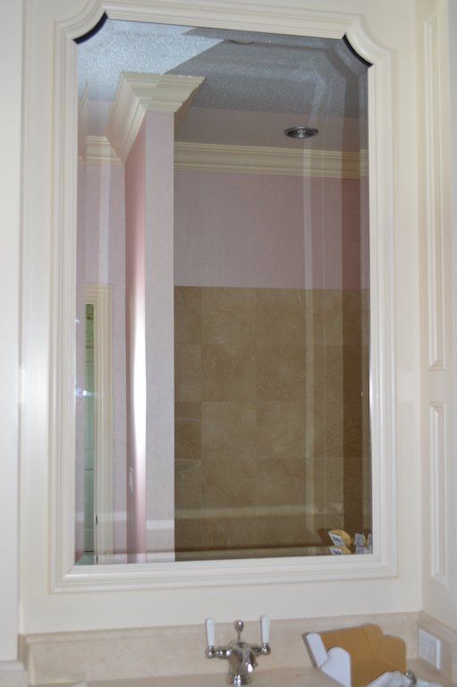 A bathroom with a sink and a mirror on the wall