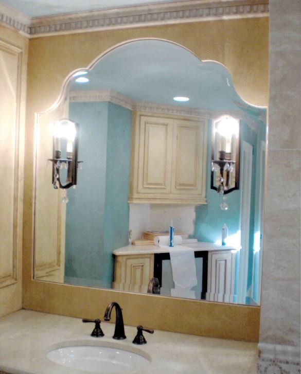 A bathroom with a large mirror and a sink