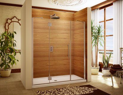 A bathroom with a walk in shower and a wooden wall.