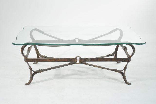 A coffee table with a glass top and a metal frame