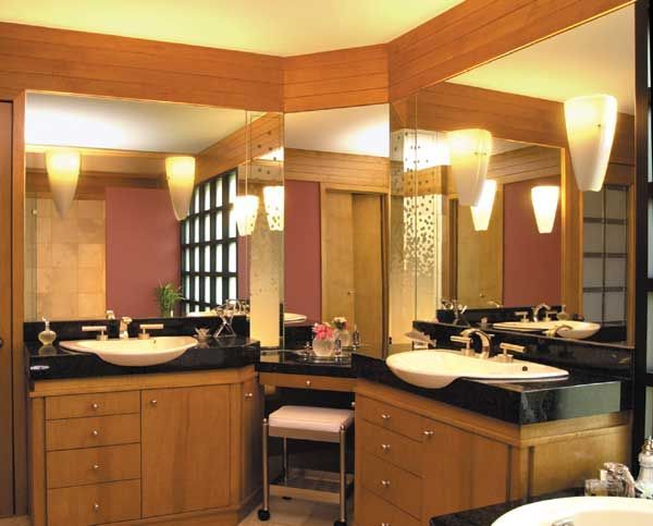 A bathroom with two sinks and two mirrors