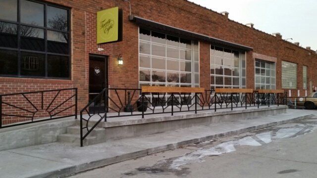 A brick building with a yellow sign on the side of it