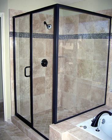 A bathroom with a walk in shower and a bathtub.