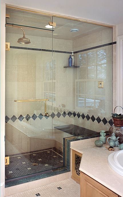 A bathroom with a walk in shower and a bathtub.