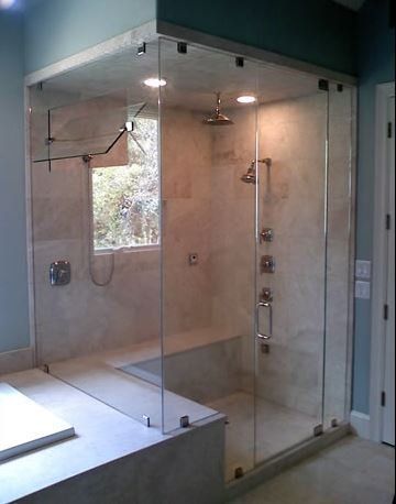A bathroom with a walk in shower and a bathtub.