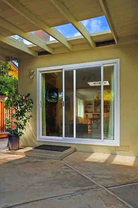 A patio with a sliding glass door leading to a living room