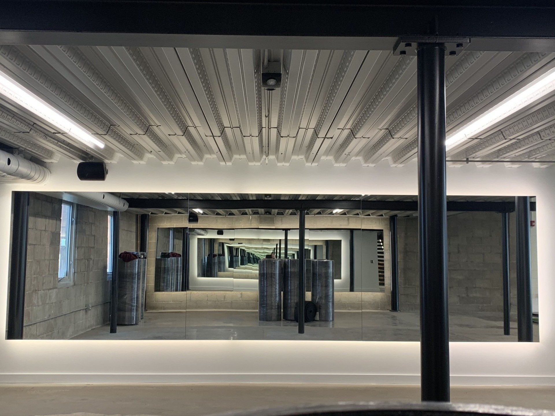 A large room with a lot of mirrors on the wall and ceiling.