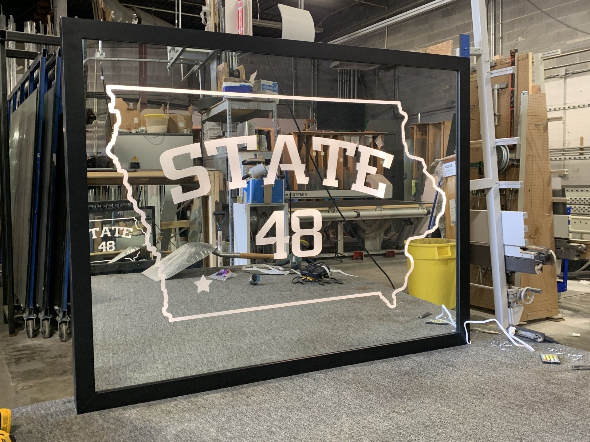A large mirror with the state of iowa on it