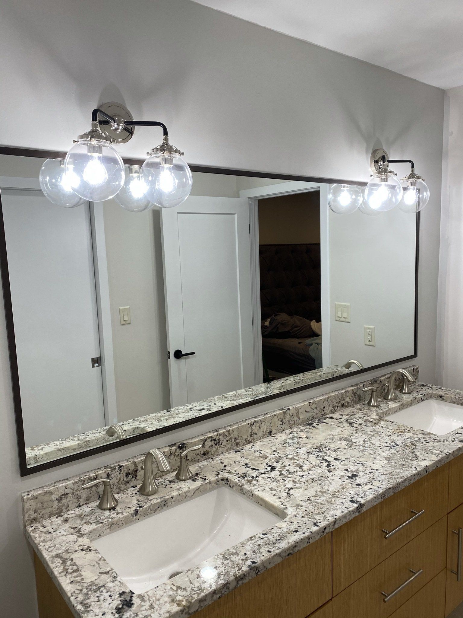 A bathroom with two sinks and a large mirror.