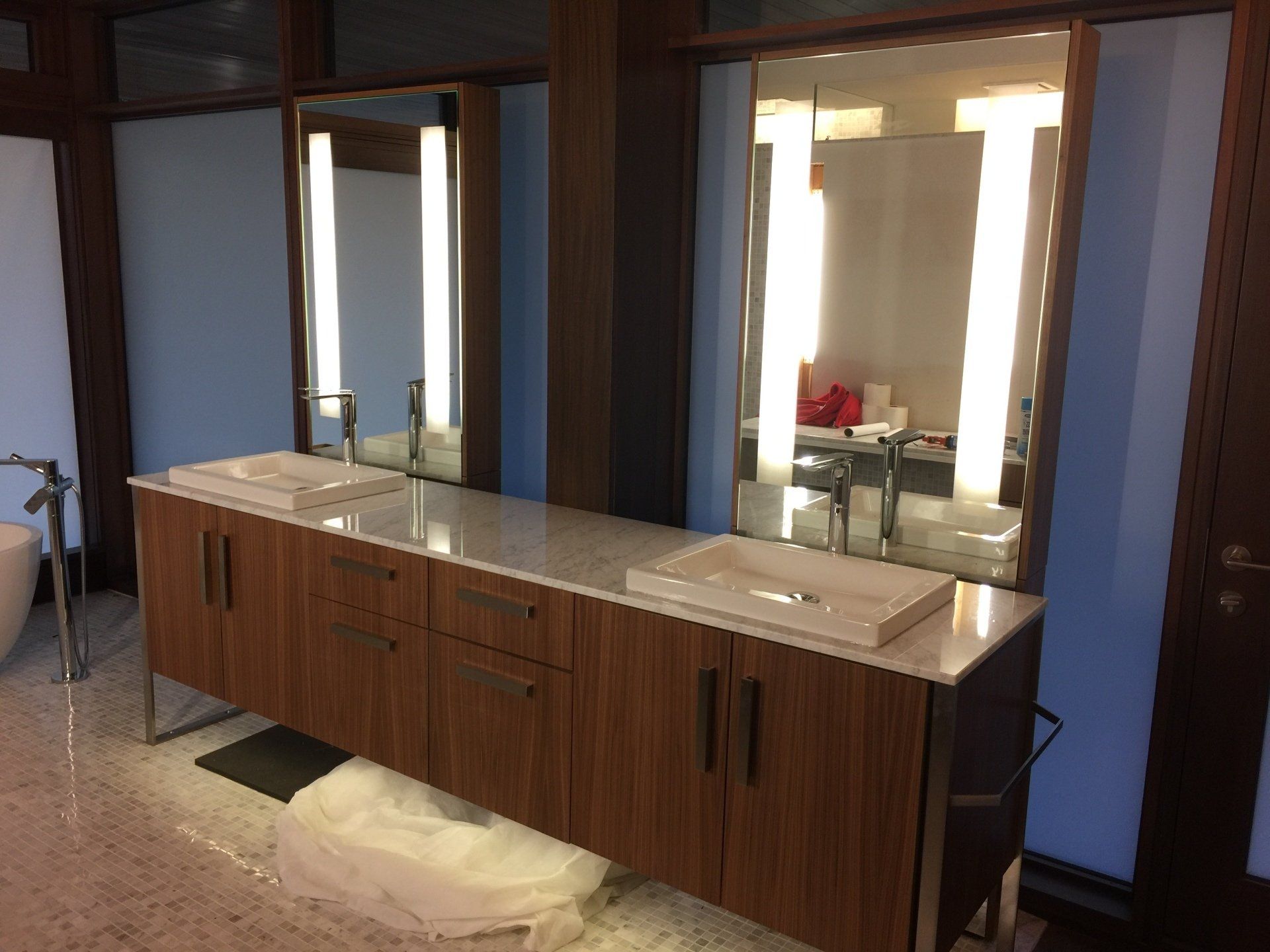 A bathroom with two sinks and two mirrors.