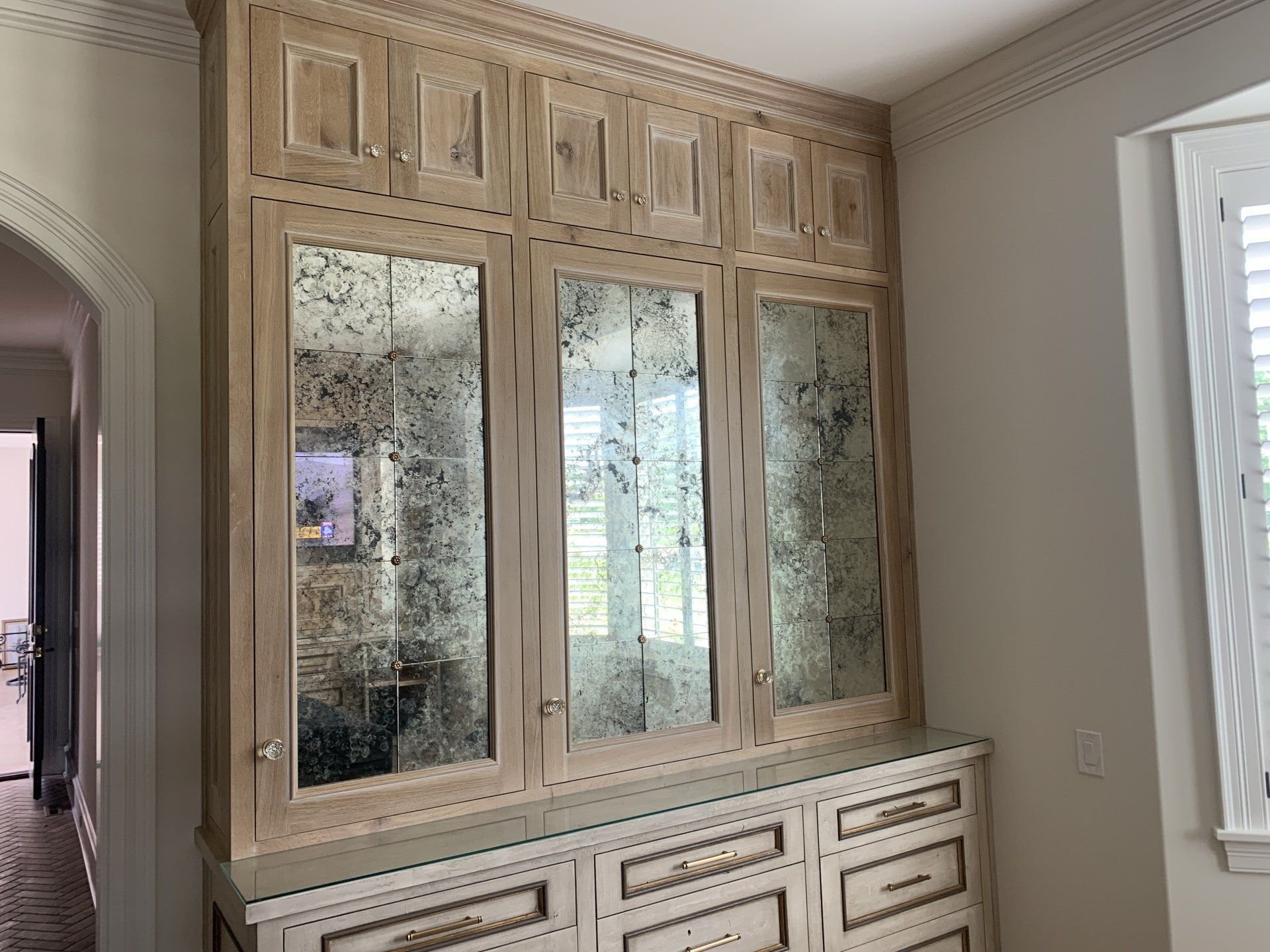 A room with a lot of cabinets and a window.