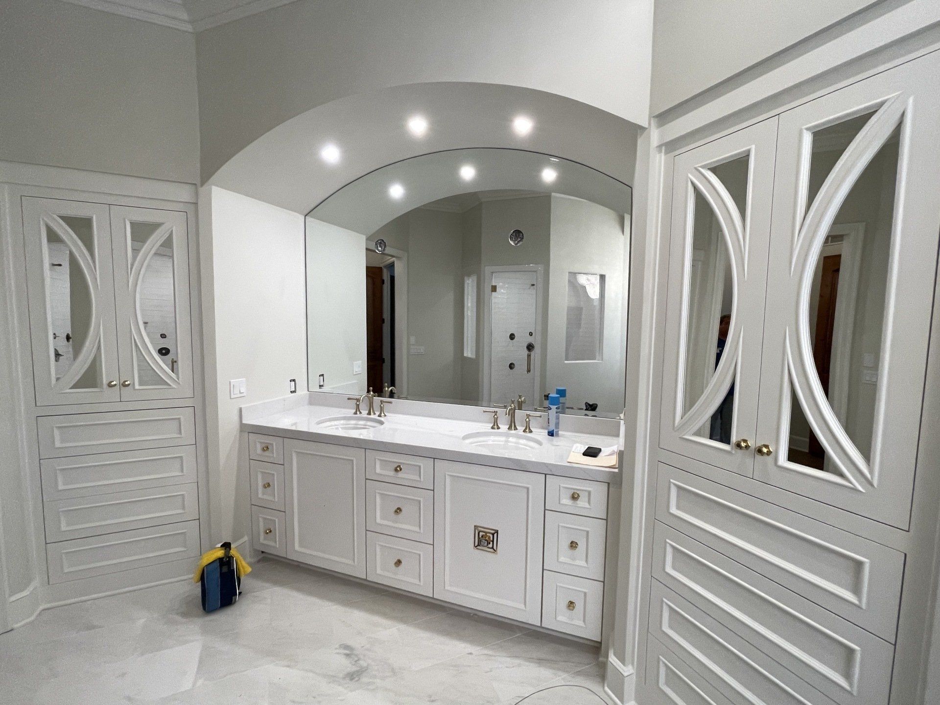 A bathroom with two sinks and a large mirror.