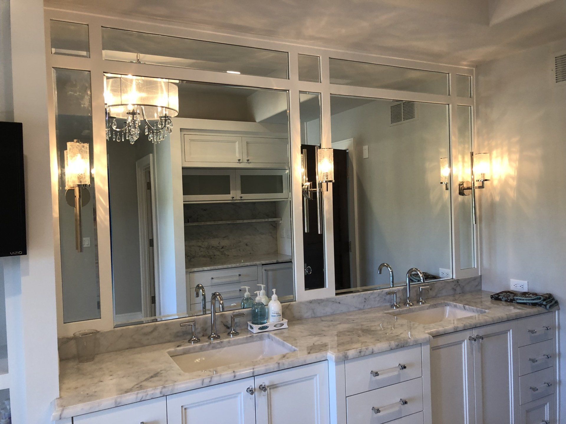 A bathroom with two sinks and a large mirror