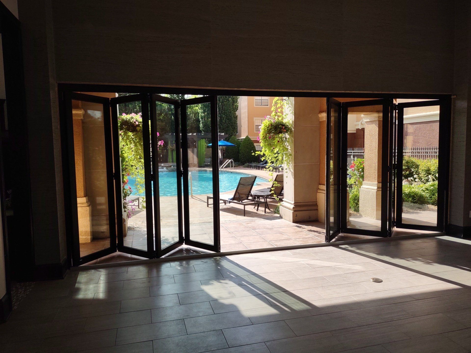 A large room with a swimming pool in the background