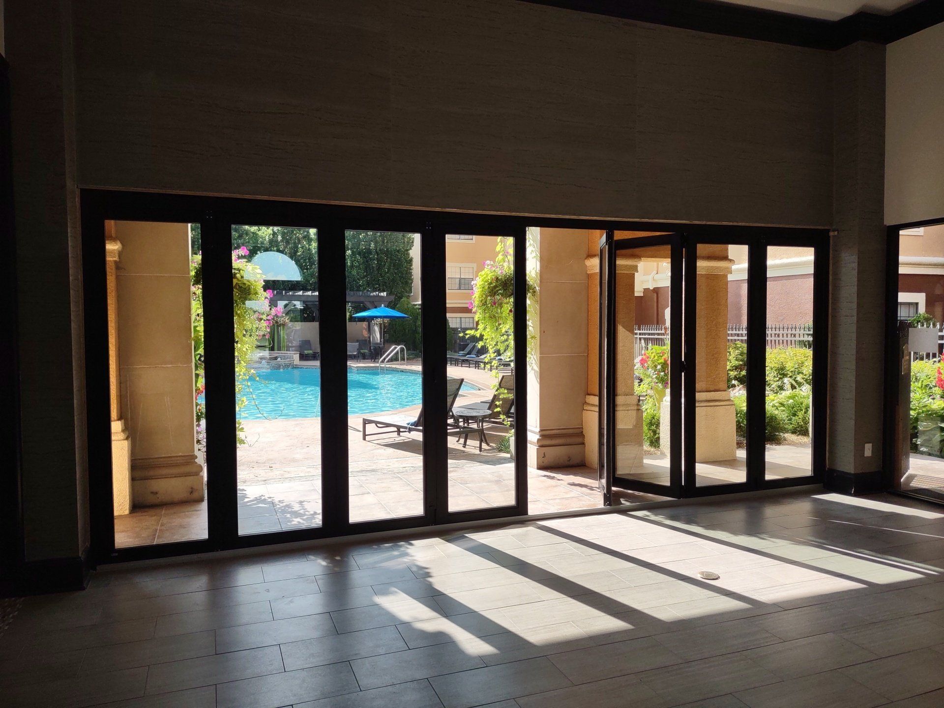 A large room with a swimming pool in the background