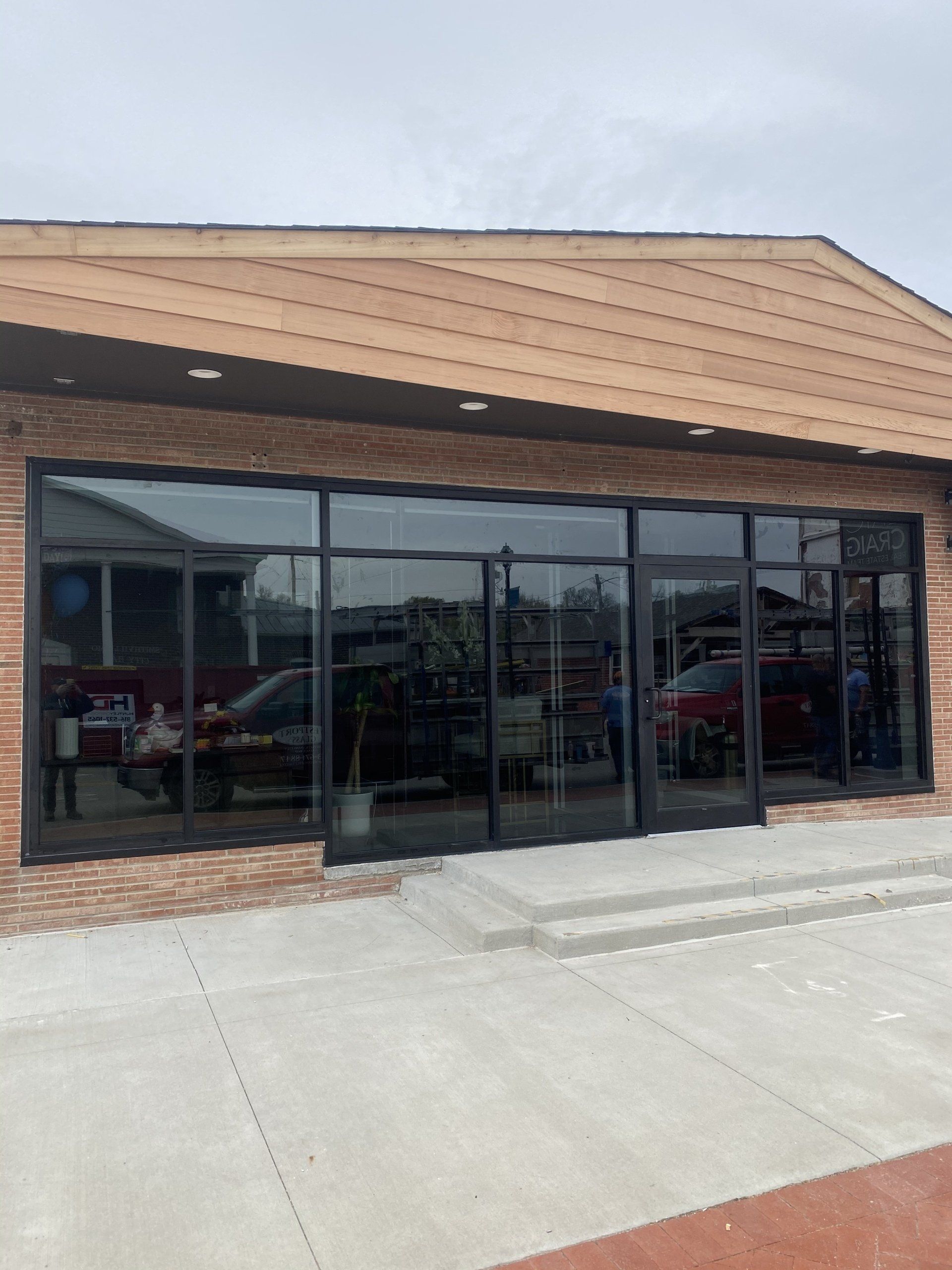 A large building with a lot of windows and a brick roof.