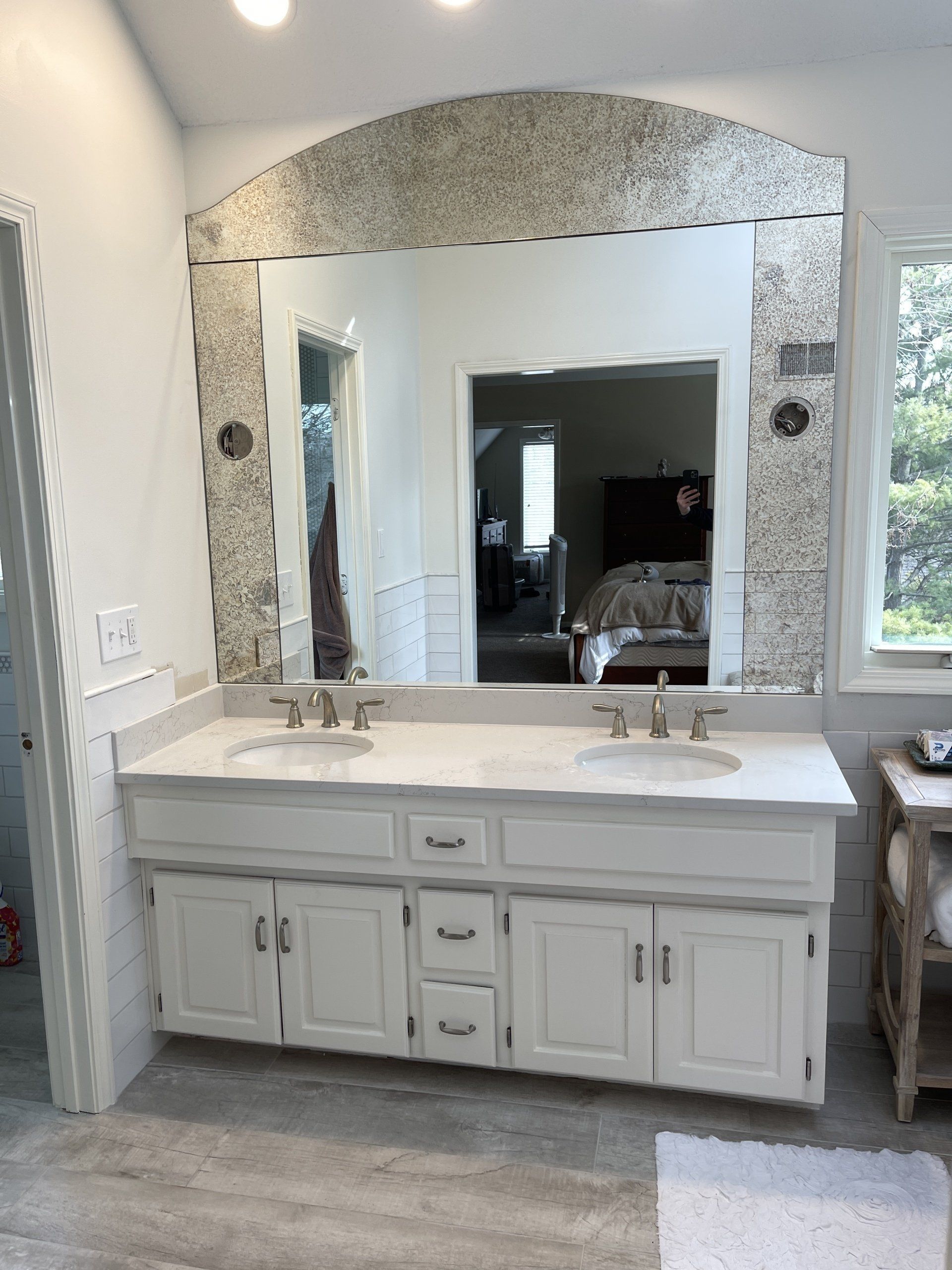 A bathroom with two sinks and a large mirror.