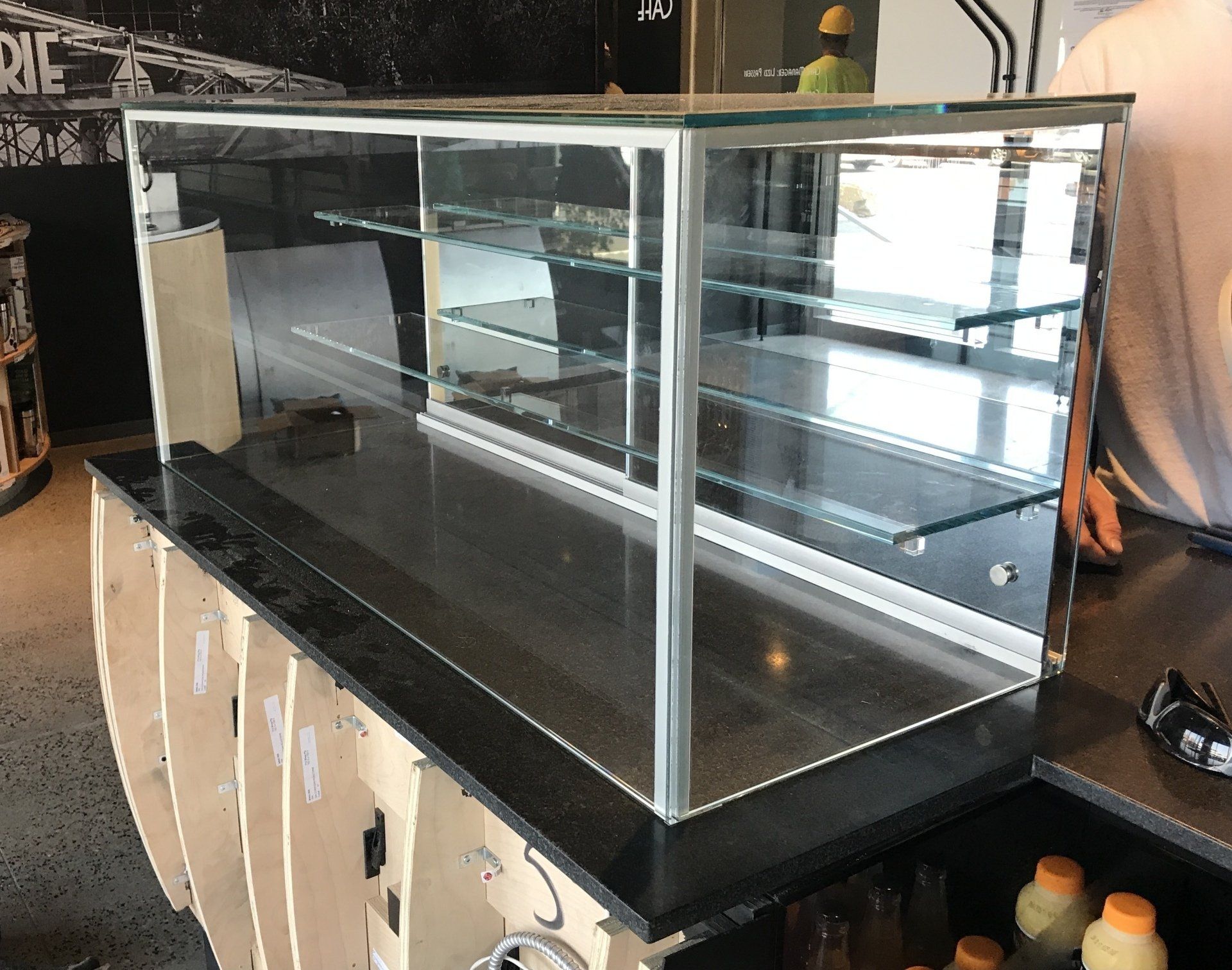A glass display case is being built in a restaurant