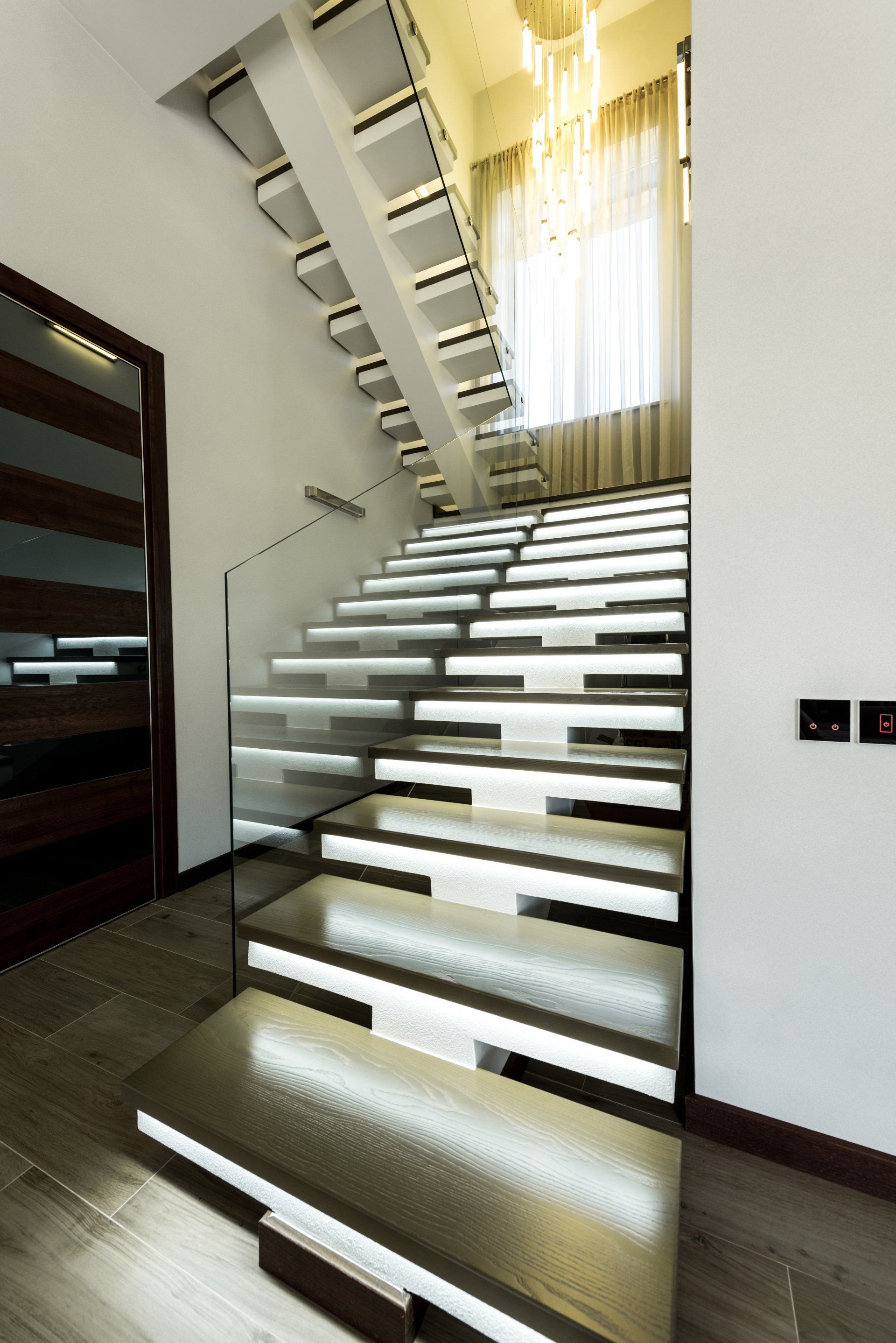 A modern staircase with lights on the steps