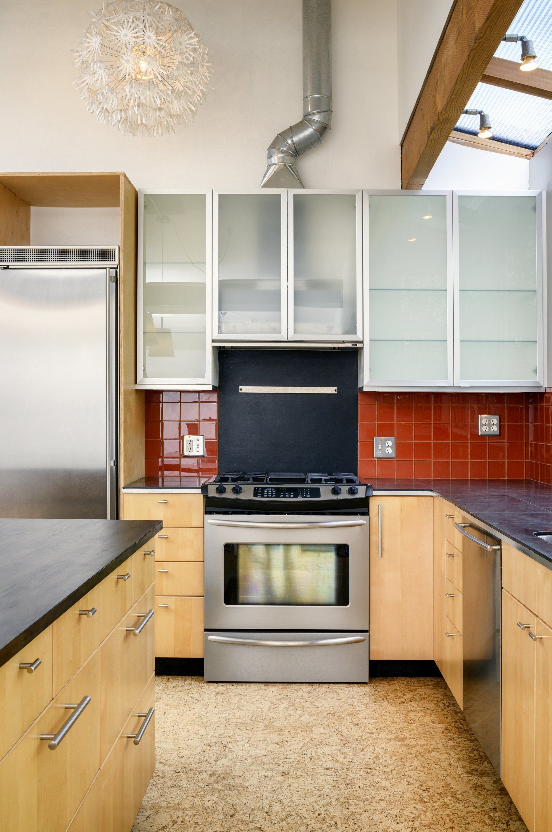 A kitchen with stainless steel appliances and wooden cabinets