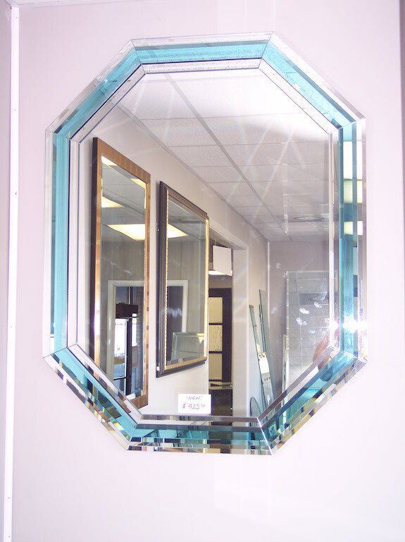 A mirror with a blue frame is hanging on a wall