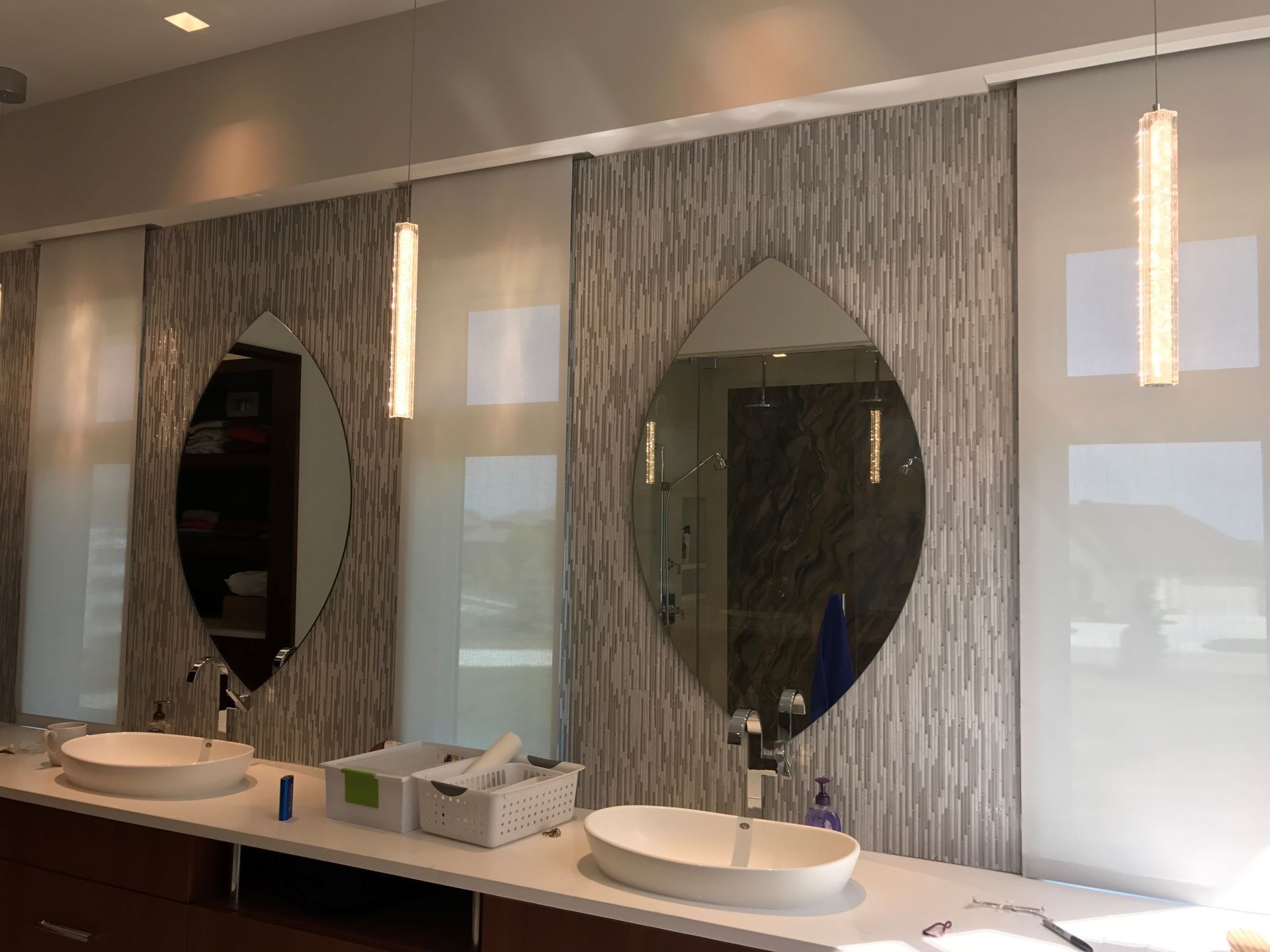 A bathroom with two sinks and three mirrors.
