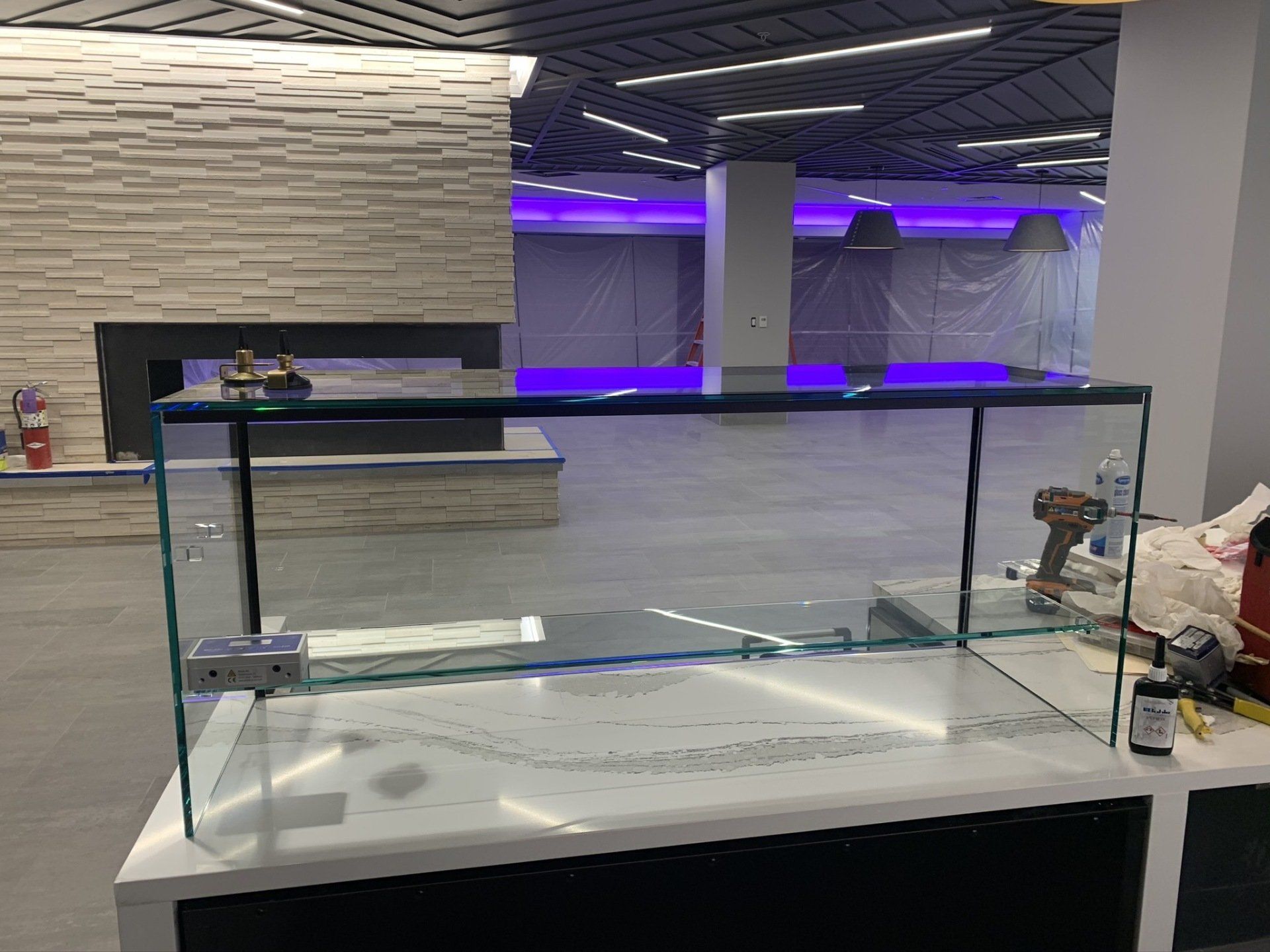 A glass display case is sitting on top of a counter in a room.