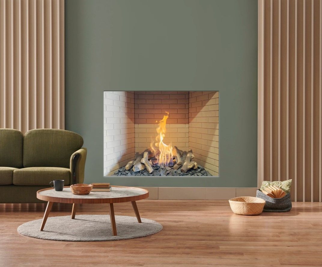 Fireplace with a stone facade, flanked by wooden shelving and a cabinet. Above the fireplace is a mounted deer head.