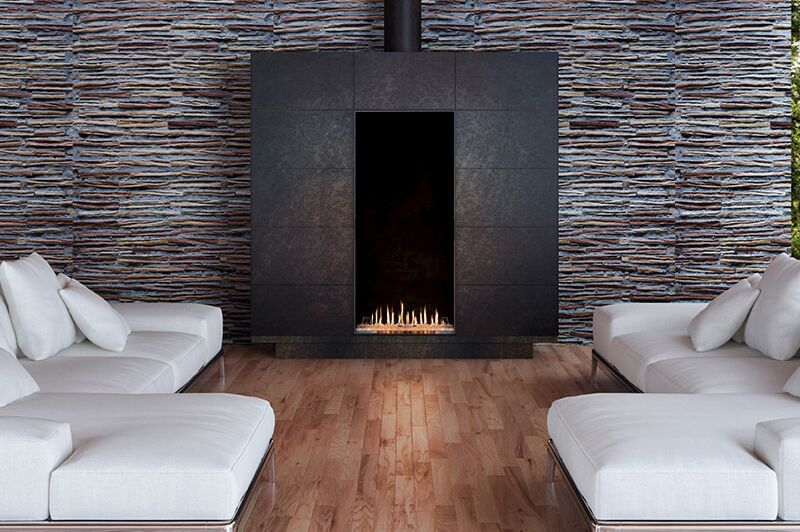 A modern fireplace built into a gray wall with a TV above, logs and flames visible.