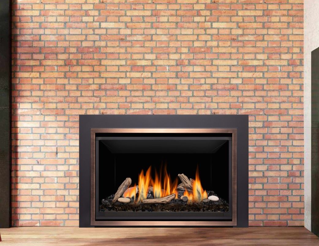 A fireplace with burning flames and wood logs, set against a brick wall and framed in black and copper.