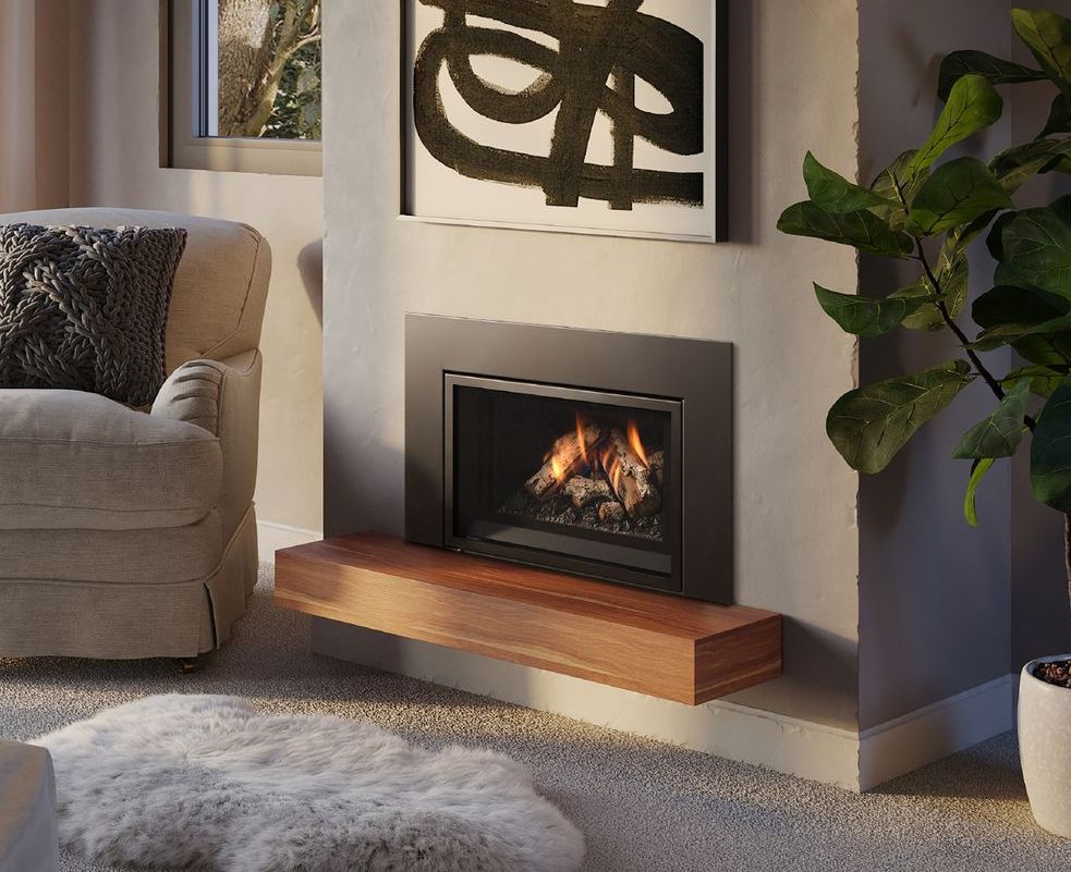 Modern fireplace with flames, black surround, and a floating wood hearth. The scene includes a living room with a chair, artwork, and a houseplant.