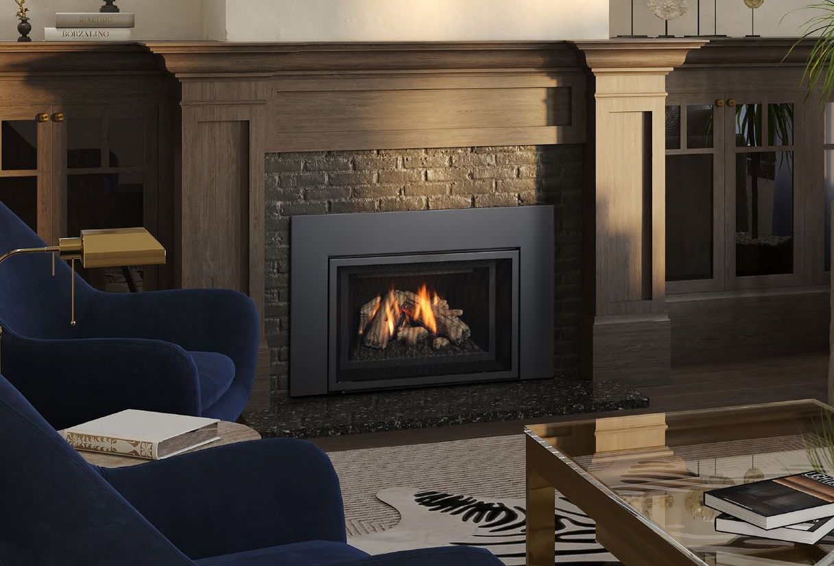 Fireplace with a black frame, surrounded by brick and a wooden mantel, in a living room with blue armchairs and a zebra-print rug.