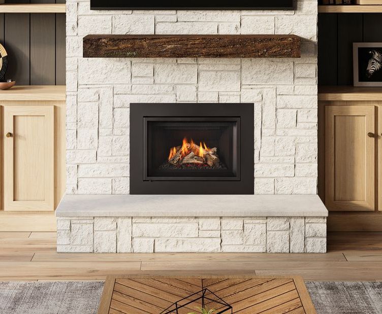 Fireplace with a roaring fire, set in a white brick wall with a wooden mantel. Wooden cabinetry and a stone hearth complete the design.