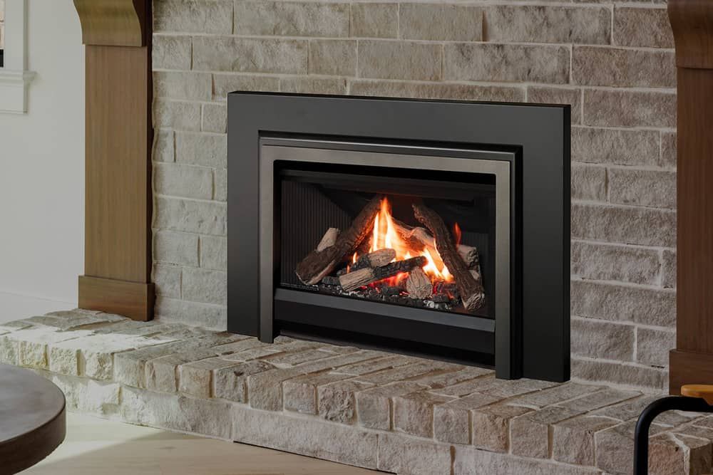 A gas fireplace with burning logs is set into a gray brick hearth and surround.