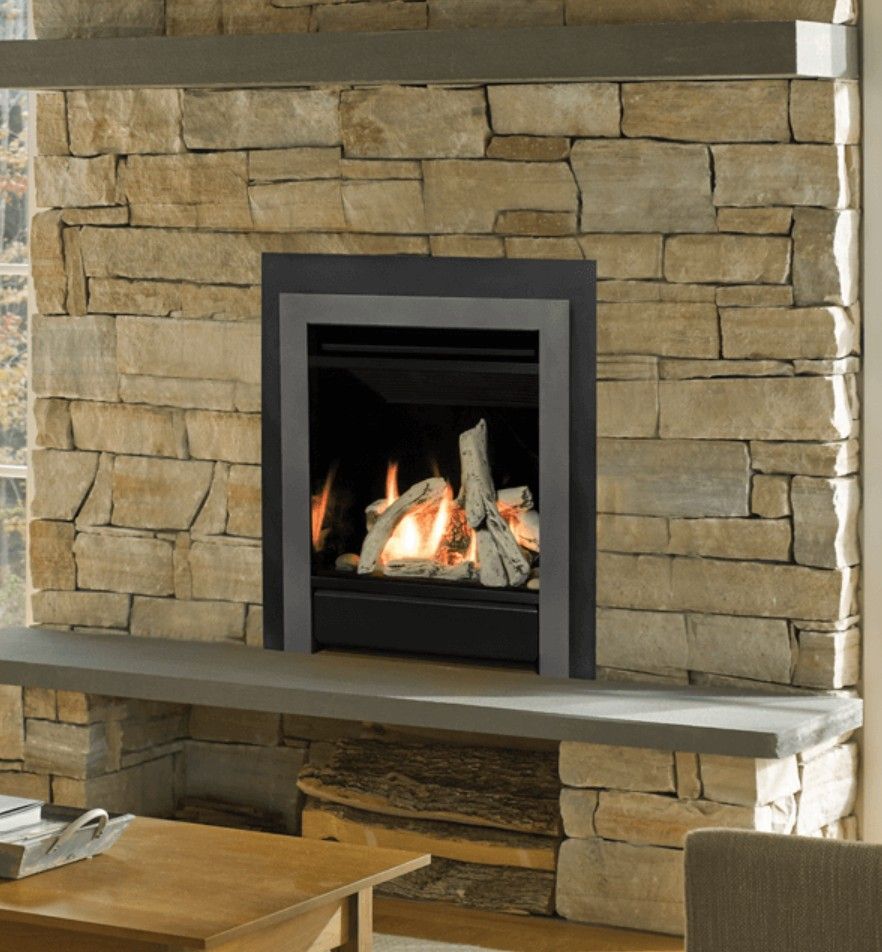 Living room with a fireplace, glass doors, and neutral décor. A fire burns inside the fireplace.
