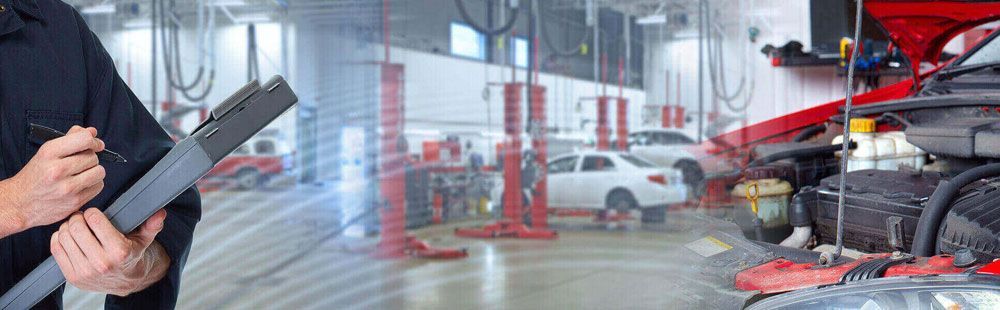 Man with clipboard in garage | Eagle Transmission & Auto Repair - Pearland