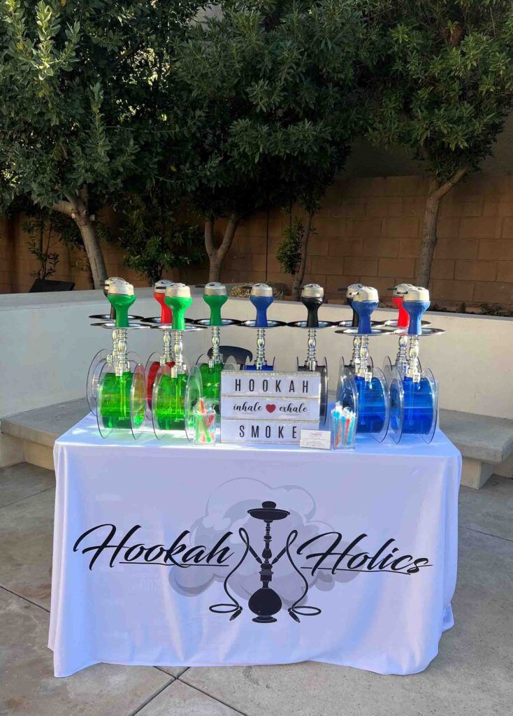 A table with hookahs on it and a sign that says hookah holics