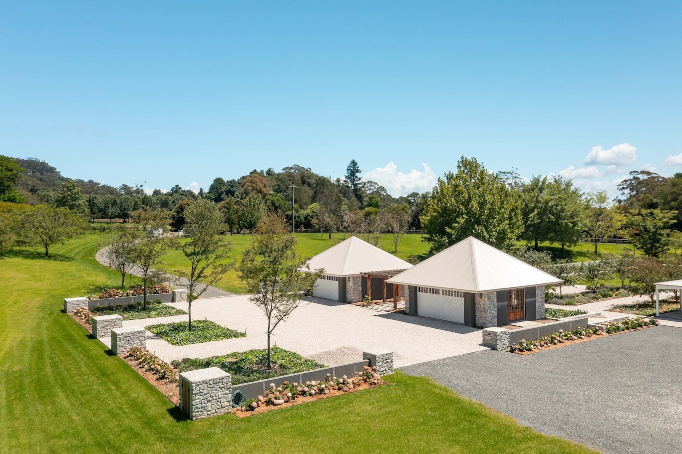 Modern Carport With New Garages Surrounded By Grass And Trees — Ridgeline Building Co In Jamberoo, NSW