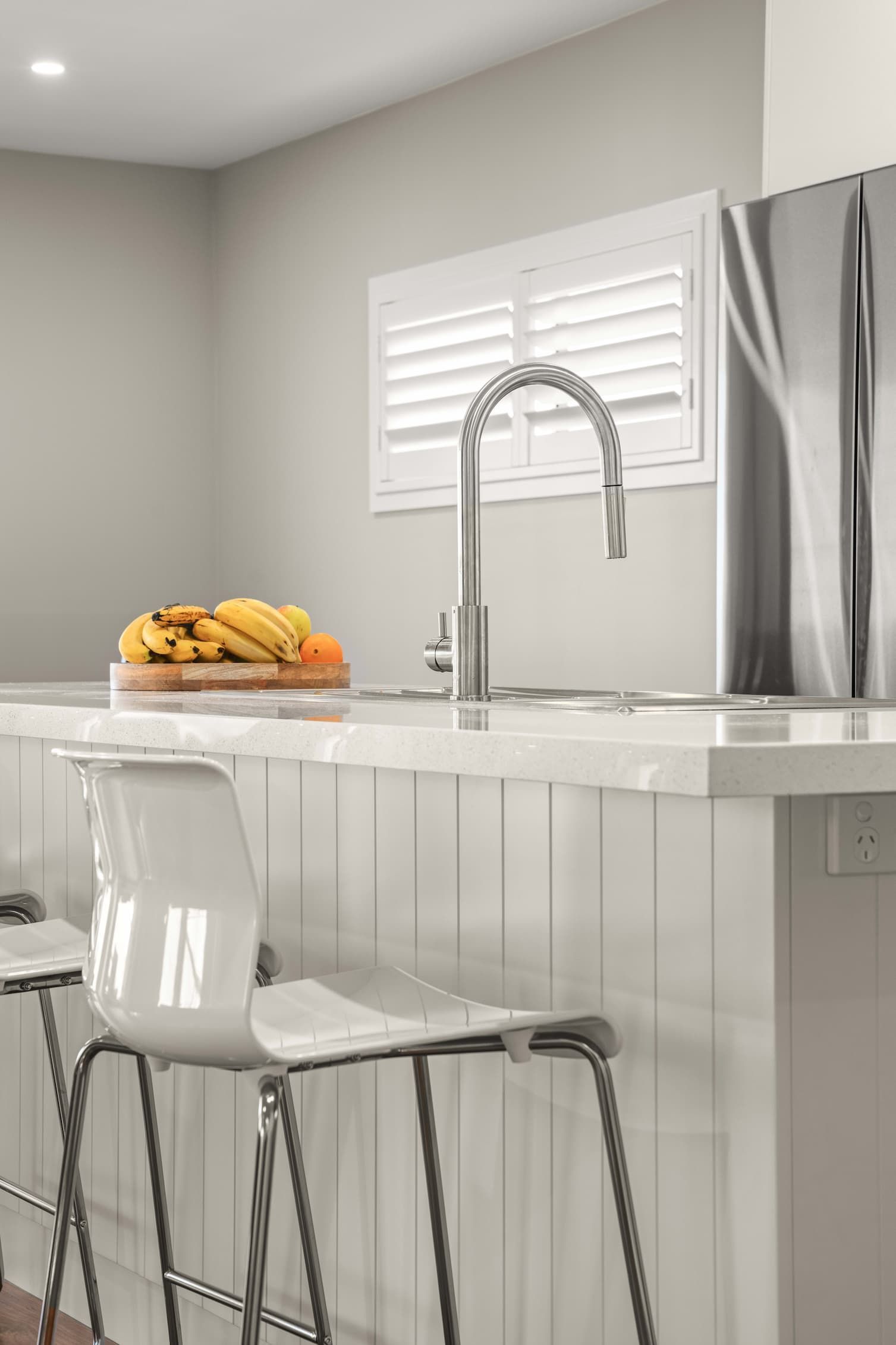A Kitchen Island With Fruit On the Bench And Bar Stools — Ridgeline Building Co In Gerringong, NSW