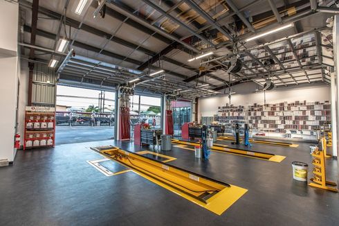 A large garage with a lot of tools and equipment in it.