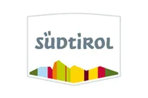 A logo for sudtirol with a mountain in the background